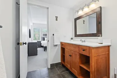 a bathroom with a sink and a mirror at Modern Mountainside Ski in Ski out 87111 in Blue Mountains