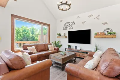 a living room with leather furniture and a flat screen tv at Luxurious Arlberg Retreat 89883 in Blue Mountains