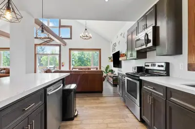 a kitchen with stainless steel appliances and a living room at Luxurious Arlberg Retreat 89883 in Blue Mountains