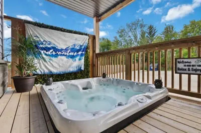 a hot tub on a deck with a flag at Luxurious Arlberg Retreat 89883 in Blue Mountains