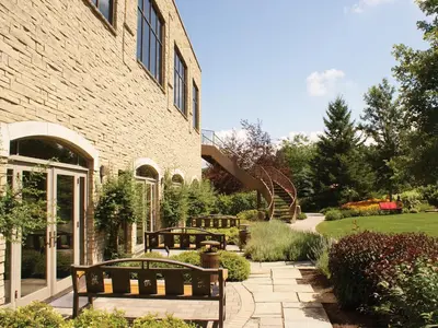 two benches sitting in front of a brick building at White Oaks Conference & Resort Spa in Niagara on the Lake