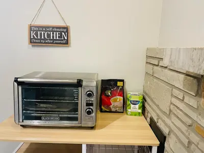 a microwave sitting on top of a wooden table at MT house in Mississauga