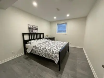 a bedroom with a bed and a window at MT house in Mississauga