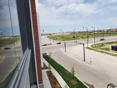 a view from a window of a street with traffic at Luxurious Condo Apartment 2BRs-1BAs-1Office with free parking in Brampton