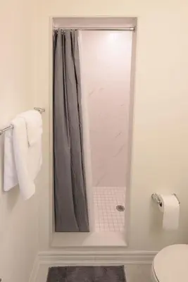 a shower with a glass door in a bathroom at Luxurious Condo Apartment 2BRs-1BAs-1Office with free parking in Brampton