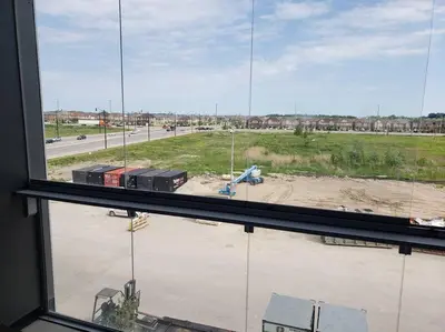 a view from a window of a construction site at Luxurious Condo Apartment 1BR-1BA-1Office free parking in Brampton