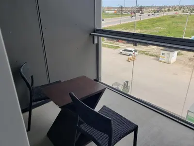 a table and chairs in a room with a window at Luxurious Condo Apartment 1BR-1BA-1Office free parking in Brampton