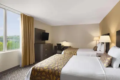 a hotel room with two beds and a window at Travelodge by Wyndham Niagara Falls Fallsview in Niagara Falls