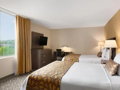 a hotel room with two beds and a large window at Travelodge by Wyndham Niagara Falls Fallsview in Niagara Falls