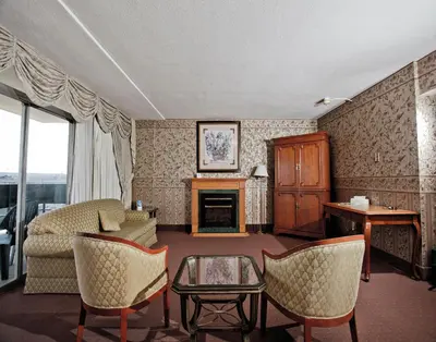 a living room with a couch and a fireplace at Travelodge by Wyndham Niagara Falls Fallsview in Niagara Falls