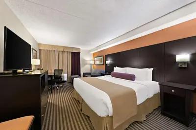 a hotel room with a large bed and a flat screen tv at Best Western Plus Toronto North York Hotel & Suites in Toronto