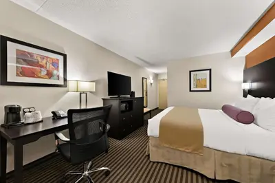 a hotel room with a bed and a desk at Best Western Plus Toronto North York Hotel & Suites in Toronto
