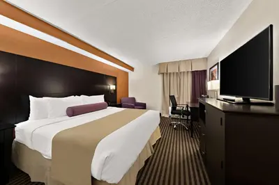 a hotel room with a large bed and a flat screen tv at Best Western Plus Toronto North York Hotel & Suites in Toronto