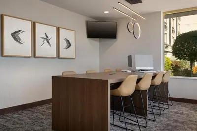 a conference room with a desk with chairs and a computer at Holiday Inn Hotel & Suites St.Catharines-Niagara by IHG in St. Catharines