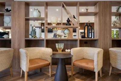 a restaurant with chairs and a table and shelves at Holiday Inn Hotel & Suites St.Catharines-Niagara by IHG in St. Catharines