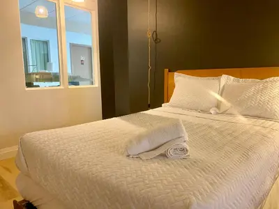 a bedroom with a white bed with a window at Ranch House Inn in Exeter