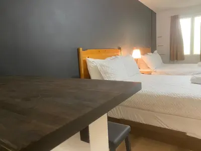 a hotel room with two beds and a table at Ranch House Inn in Exeter