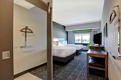 a hotel room with a bed and a television at Hampton Inn St. Catharines Niagara in St. Catharines