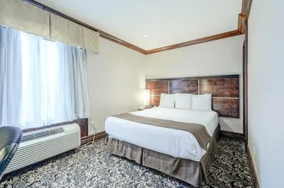 a hotel room with a bed and a window at Woodbine Hotel & Suites in Toronto