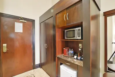 a bathroom with a toilet and a microwave at Woodbine Hotel & Suites in Toronto