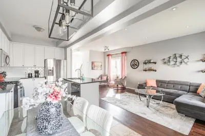 a kitchen and living room with a couch and a table at GlobalStay 3 Bedroom Townhome with Hot Tub Hamilton in Hamilton