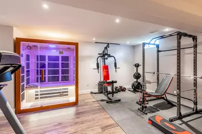 a fitness room with tread machines and a window at GlobalStay 3 Bedroom Townhome with Hot Tub Hamilton in Hamilton