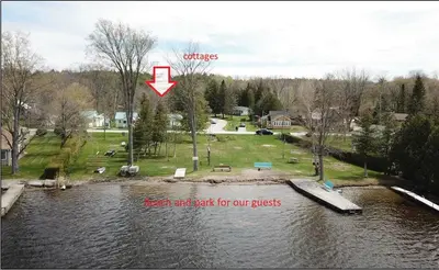 an aerial view of a river with a red and start for our grass at Fun Place with a Sandy Beach for Swimming, Boating & Fishing, Featuring 1 House and 3 Cabins in Fenelon Falls