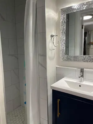 a bathroom with a sink and a shower with a mirror at Hammer Haus III in Waterloo