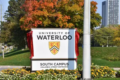 a sign for the university of waterloo in a park at Hammer Haus III in Waterloo