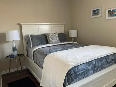 a bedroom with a large bed with two lamps at Hammer Haus III in Waterloo