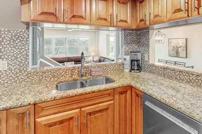 a kitchen with wooden cabinets and a sink at Wintergreen 119 in Blue Mountains