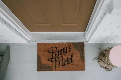a sign on a wall that reads family killed at Penny's Motel in Thornbury