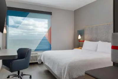 a bedroom with a bed and a desk and a window at avid Hotel - Toronto - Vaughan Southwest by IHG in Vaughan