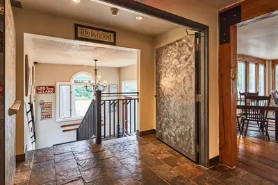 a hallway with a door leading to a dining room at 3 Pines Lodge Muskoka in Huntsville