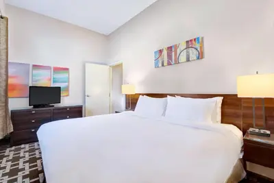 a bedroom with a large white bed and a tv at Willowdale Hotel Toronto North York in Toronto