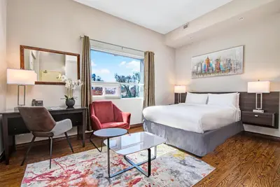 a hotel room with a bed and a desk and chairs at Willowdale Hotel Toronto North York in Toronto
