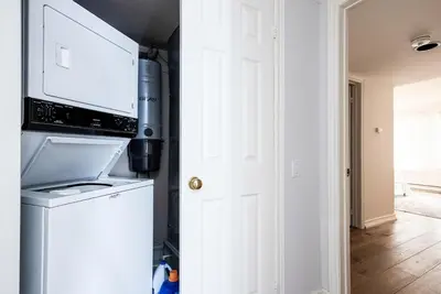 a kitchen with a microwave above a washer and dryer at Luxurious Blue Mountain 3BR & 3BTH Walk-in to Village in Blue Mountains
