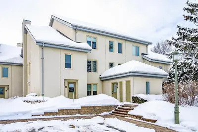 a large building with snow on the ground at Luxurious Blue Mountain 3BR & 3BTH Walk-in to Village in Blue Mountains