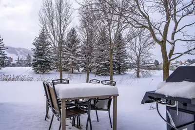 a table and chairs covered in snow in a yard at Luxurious Blue Mountain 3BR & 3BTH Walk-in to Village in Blue Mountains