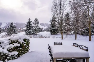 a table and chairs covered in snow in a yard at Luxurious Blue Mountain 3BR & 3BTH Walk-in to Village in Blue Mountains