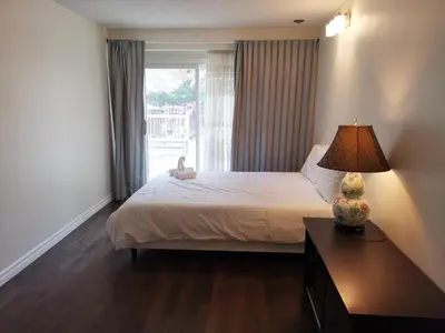a bedroom with a bed with a lamp and a window at Private Rooms in House in North York Shared Kitchen in Toronto