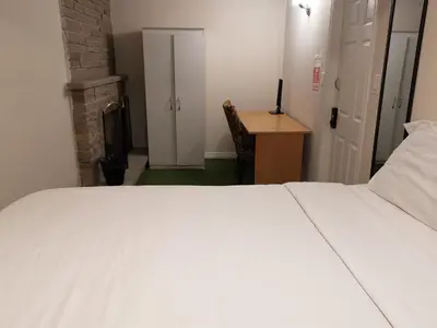 a bedroom with a large white bed and a desk at Private Rooms in House in North York Shared Kitchen in Toronto