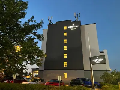 a building with cars parked in a parking lot at Country Inn & Suites by Radisson, Niagara Falls, ON in Niagara Falls
