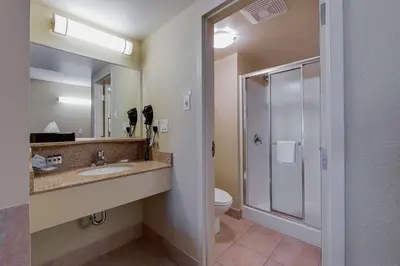 a bathroom with a sink and a toilet and a shower at Country Inn & Suites by Radisson, Niagara Falls, ON in Niagara Falls