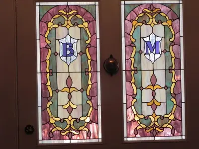 two stained glass doors with the letter b on them at Brockamour Manor Bed and Breakfast in Niagara on the Lake