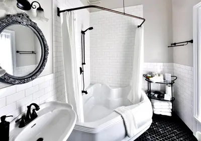 a white bathroom with a tub and a sink at Brockamour Manor Bed and Breakfast in Niagara on the Lake