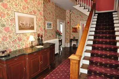 a room with a staircase and a stair case at Brockamour Manor Bed and Breakfast in Niagara on the Lake
