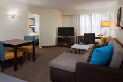 a living room with a couch and a table in a hotel room at Residence Inn by Marriott Toronto Airport in Toronto
