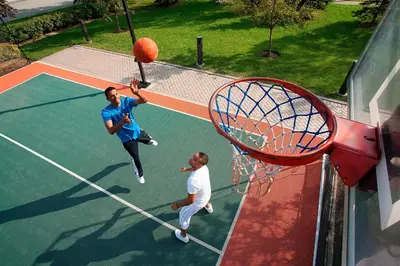 two men playing a game of basketball on a court at Residence Inn by Marriott Toronto Airport in Toronto