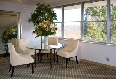 a dining room table with chairs and a vase with flowers at Guest House on the Mount in London